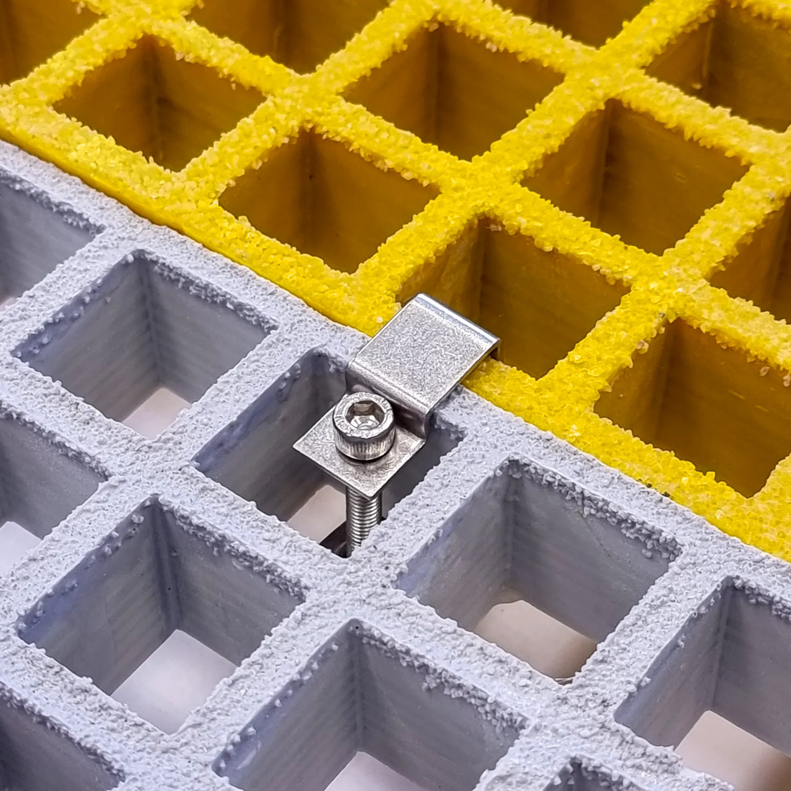 G-Clamp Panel-to-Panel Fixing (also known as C-Clip)
Fastens two open mesh GRP panels side-by-side
Reduces panel deflection between adjacent panels in areas with reduced underside support
Available for panel depths: 25mm, 38mm, 50mm.
Hex-bolt fastened, smooth, trip-free solution for securely joining panels