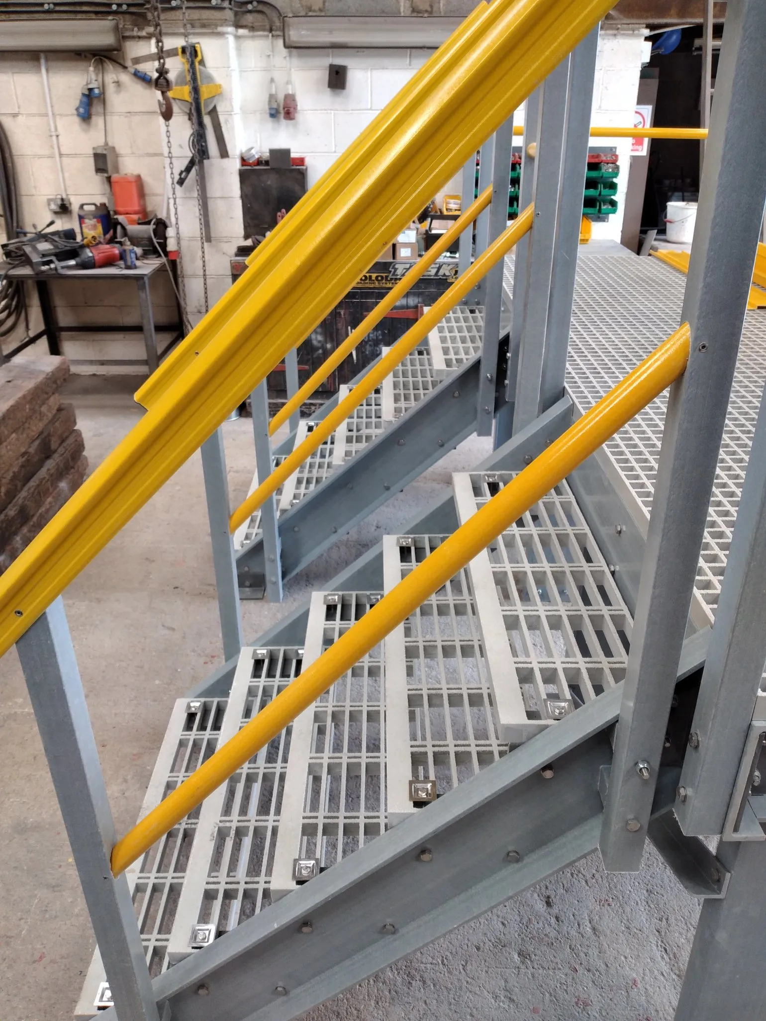 Typical Applications
GRP stair treads are widely used in:
Industrial staircases and platforms
External access stairs
Water, utilities and process environments
Rail, construction and infrastructure projects
Areas exposed to moisture, chemicals or weather
Installation and Fixings
GRP stair treads can be installed onto steel or GRP stair structures and are compatible with standard GRP fixing systems. For typical installations, we recommend four M-Clip fixings per stair tread to ensure secure and stable fixing.
Our team can advise on fixing arrangements and compatibility with existing stair structures.