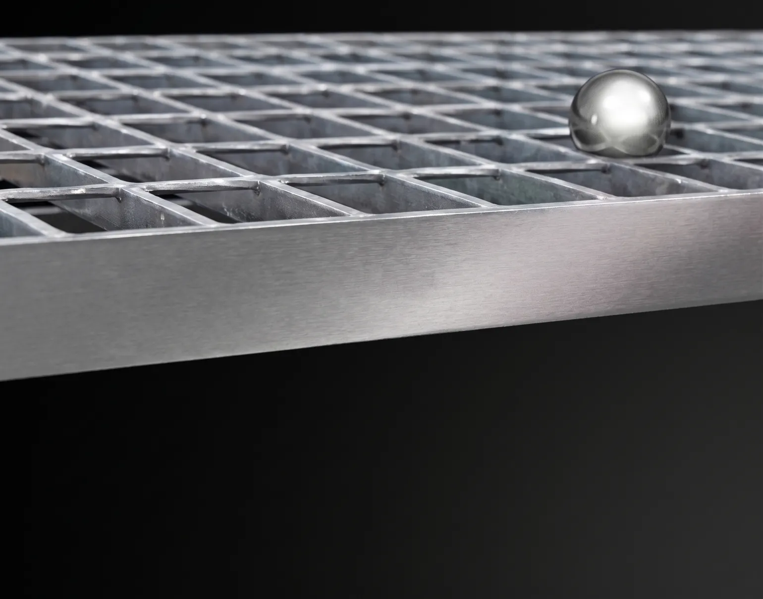 Ball Proof Steel Flooring
Ball proof grating is specified where there is a risk of objects falling from a walkway or platform onto areas below. The size of the apertures is controlled to prevent the passage of a defined sphere diameter, helping to protect people, equipment and working areas.
20mm Ball Proof Grating
20mm ball proof flooring is used where walkways or platforms are positioned above permanent working areas or machinery. The aperture design prevents the passage of a 20mm diameter sphere, reducing the risk of tools or components falling onto personnel below. Typical applications include production lines and plant rooms.
35mm Ball Proof Grating
35mm ball proof flooring is intended for areas where people pass beneath occasionally rather than continuously. It prevents the passage of a 35mm diameter sphere and is commonly used for maintenance access routes, industrial plants, unmanned substations and data centres where controlled access is in place.