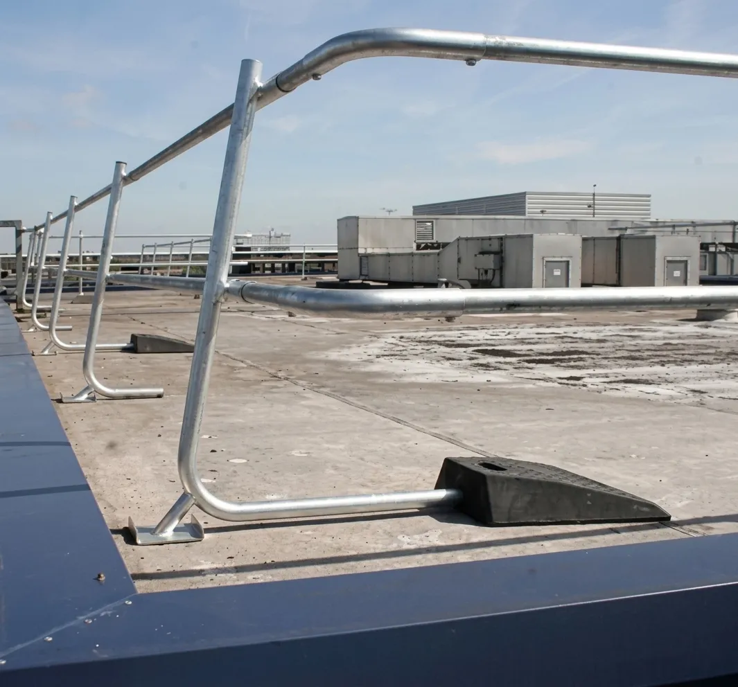 Roof edge protection systems play a vital role in preventing falls from height. They provide a secure barrier along roof perimeters where maintenance staff, inspectors and contractors are required to work.
The EazyRoof Freestanding and Fixed Roof Edge Protection System supplied by Barclay & Mathieson delivers a robust, compliant and cost-effective solution for both temporary and permanent roof safety applications. Designed around modular steel components and recycled plastic counterweights, the system creates a safe working environment without compromising the roof structure.
A Flexible System for Permanent or Temporary Use
EazyRoof can be installed as either a freestanding, non-penetrative system or a fixed solution, depending on roof construction, load requirements and project constraints. This flexibility makes it suitable for a wide range of roofing materials and building types.
The system is quick and easy to erect, based on pre-assembled uprights, 2.5m cross rails and slide-on counterweights, allowing rapid installation with minimal disruption on site.
Fully tested to EN 13374:2004, Class A, EazyRoof provides compliant fall protection for maintenance and access activities at roof level.