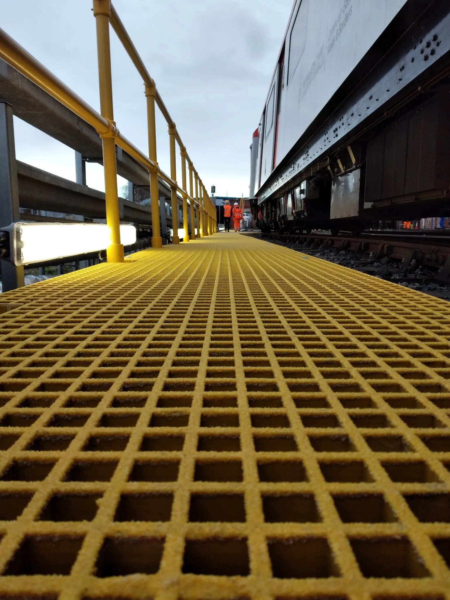 Why GRP and Steel Matter in Rail Applications
Rail projects often require a combination of materials to address differing risks and environments. We support informed material selection decisions, supplying GRP, steel or hybrid solutions depending on application, load requirements, location and maintenance programmes.
Our expertise across both materials allows us to support consistent, compliant access solutions throughout a rail asset.
Trackside Access & Maintenance Routes
Trackside environments demand safe, stable walkways for driver access, routine inspection and maintenance, and emergency access. GRP grating walkways, stair treads and step over structures are frequently specified due to their slip resistance, durability and non-conductive properties, making them suitable for use near live electrical systems.
Handrail systems in both GRP and steel can be integrated alongside walkways to provide continuous edge protection and route guidance.